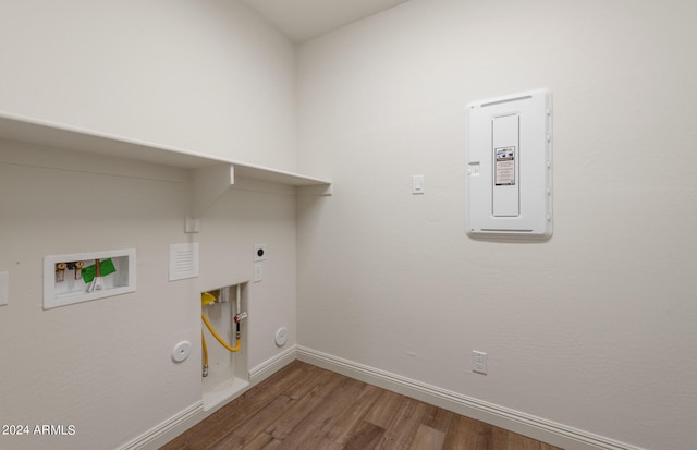 clothes washing area featuring washer hookup, electric dryer hookup, gas dryer hookup, and wood-type flooring