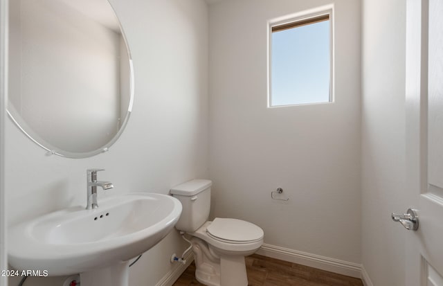 bathroom featuring sink, hardwood / wood-style flooring, and toilet