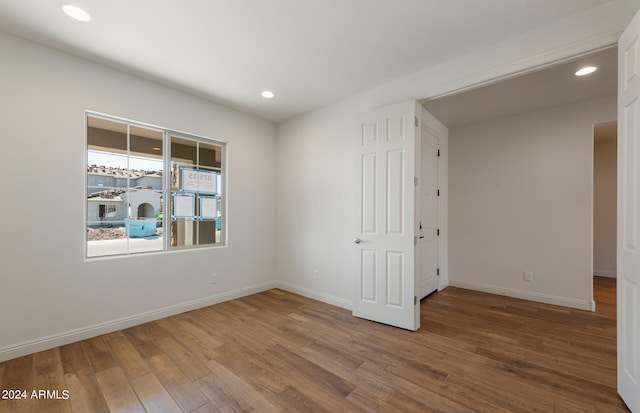 spare room featuring wood-type flooring