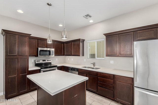 2000 N 36th St Unit 19, Phoenix, AZ 85008 - kitchen featuring appliances with stainless steel finishes, light tile patterned floors, dark brown cabinets, light countertops, and recessed lighting