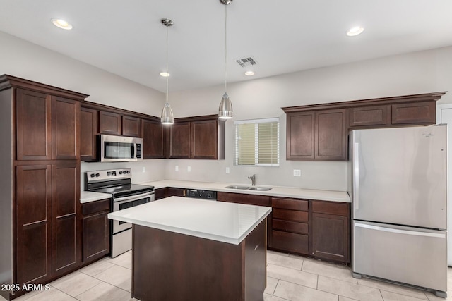 2000 N 36th St Unit 19, Phoenix, AZ 85008 - kitchen with stainless steel appliances, light tile patterned floors, dark brown cabinets, light countertops, and recessed lighting