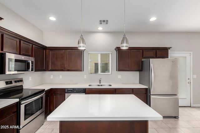 2000 N 36th St Unit 19, Phoenix, AZ 85008 - kitchen with appliances with stainless steel finishes, light countertops, dark brown cabinets, light tile patterned floors, and recessed lighting