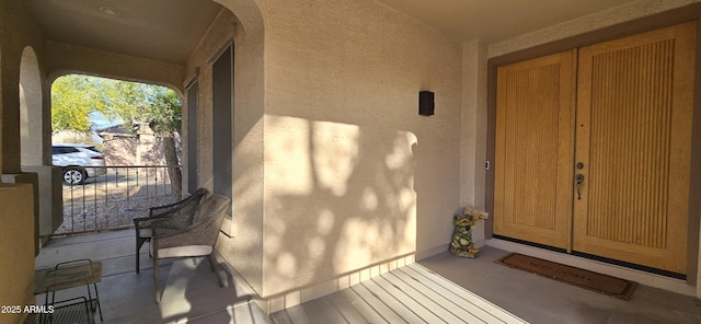 view of exterior entry with french doors and stucco siding