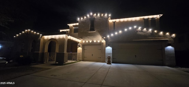 view of front facade featuring a garage, stucco siding, and concrete driveway