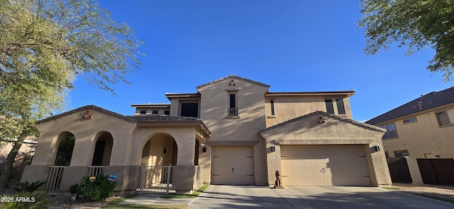 mediterranean / spanish house with stucco siding, fence, and driveway