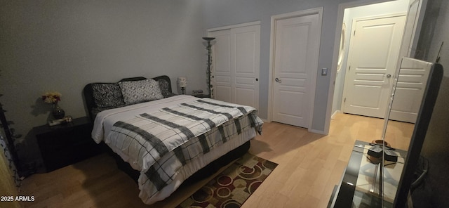 bedroom featuring light wood-style floors and a closet