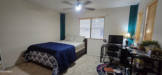 carpeted bedroom with a ceiling fan and baseboards
