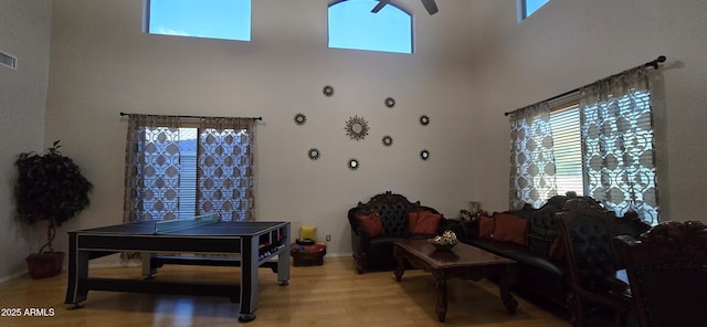 living room with a wealth of natural light, light wood finished floors, baseboards, and visible vents