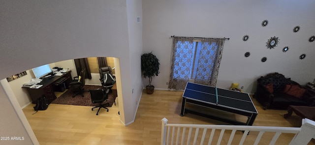 bedroom featuring baseboards and wood finished floors