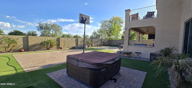 view of yard featuring a fenced backyard, outdoor dry bar, a hot tub, and a patio area