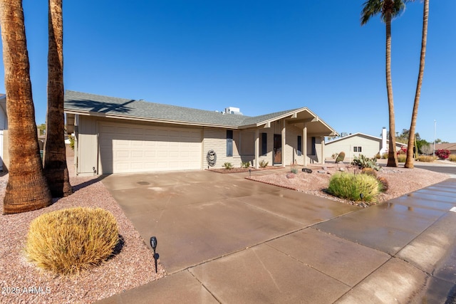 ranch-style house featuring a garage, brick siding, and driveway