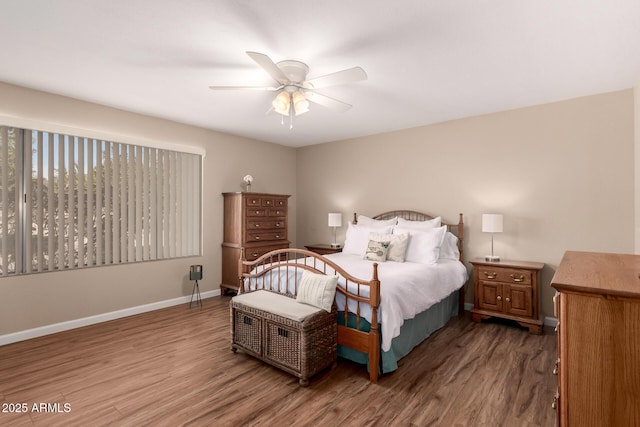 bedroom with a ceiling fan, baseboards, and wood finished floors