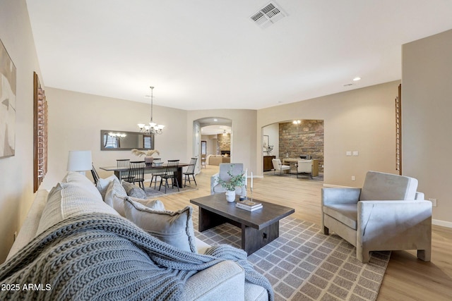 living room featuring a chandelier and light hardwood / wood-style floors