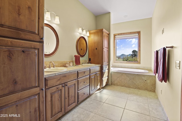 bathroom featuring vanity, tiled bath, and tile patterned floors