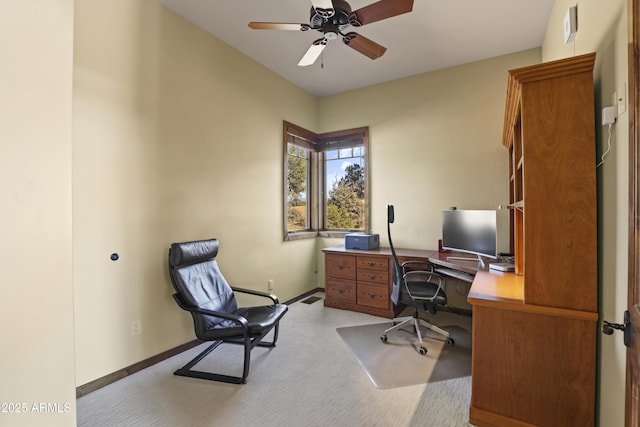 carpeted home office with ceiling fan