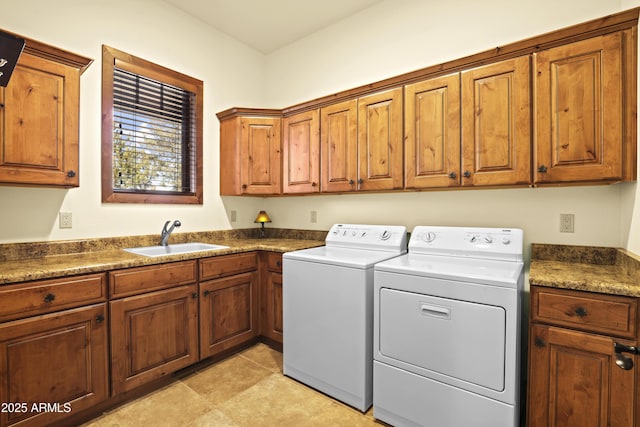 clothes washing area with separate washer and dryer, sink, light tile patterned floors, and cabinets