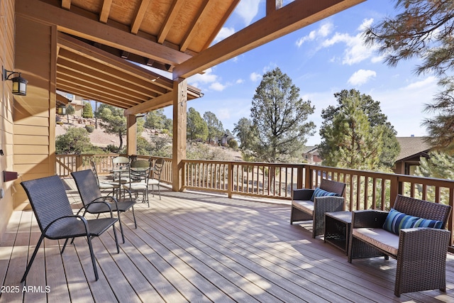 wooden terrace with an outdoor hangout area