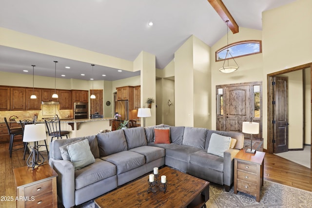 living room featuring beam ceiling, dark wood-type flooring, and high vaulted ceiling