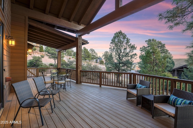 deck at dusk with an outdoor living space