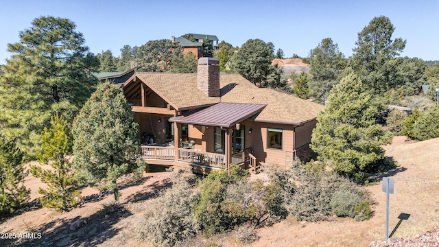 back of property featuring a wooden deck