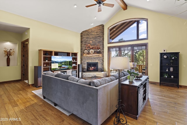 living room with beam ceiling, high vaulted ceiling, a fireplace, and light hardwood / wood-style floors