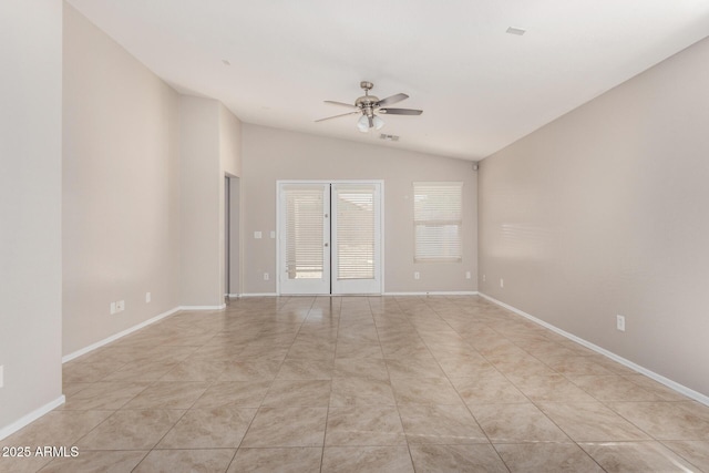 tiled empty room with ceiling fan and vaulted ceiling