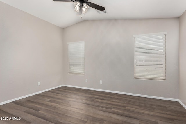 spare room with lofted ceiling, dark hardwood / wood-style floors, and ceiling fan