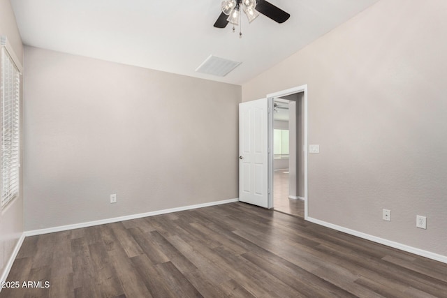 unfurnished bedroom featuring dark wood-type flooring, ceiling fan, and lofted ceiling