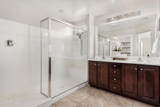 bathroom with tile patterned flooring, vanity, and an enclosed shower