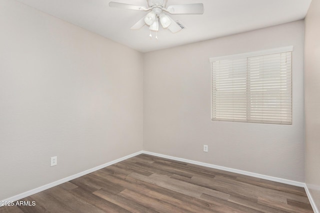 empty room with dark wood-type flooring and ceiling fan