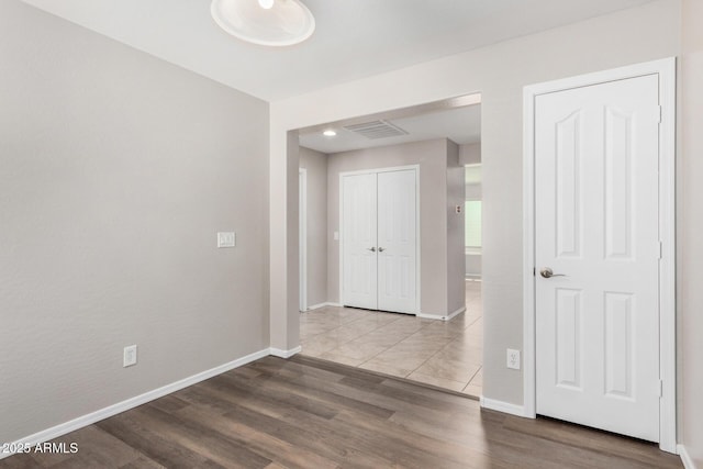 corridor with hardwood / wood-style floors