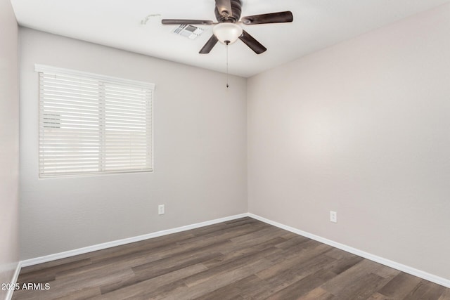 spare room featuring dark wood-type flooring and ceiling fan