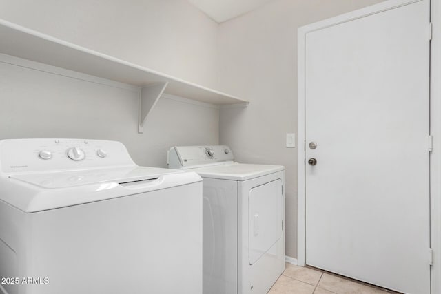 laundry area with light tile patterned floors and independent washer and dryer