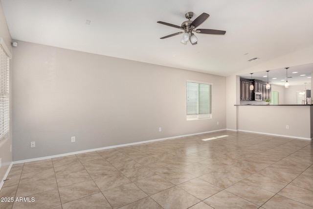 unfurnished room with ceiling fan and light tile patterned floors