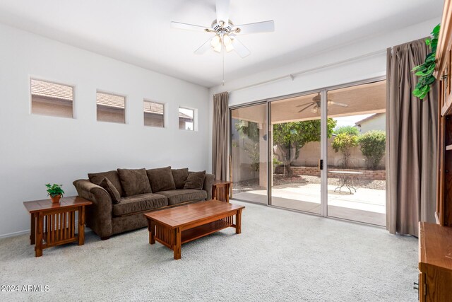 carpeted living room featuring ceiling fan and plenty of natural light