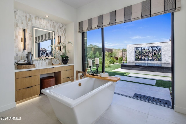 bathroom with vanity, tile patterned floors, and a bathtub