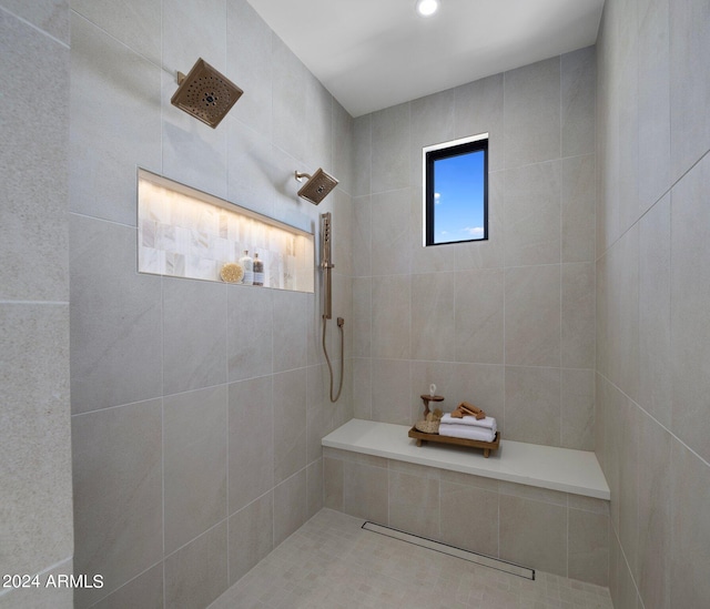 bathroom with tile walls and tiled shower