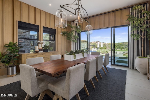 dining space featuring wood walls