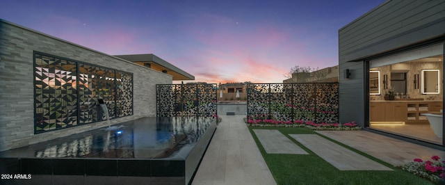 view of patio terrace at dusk