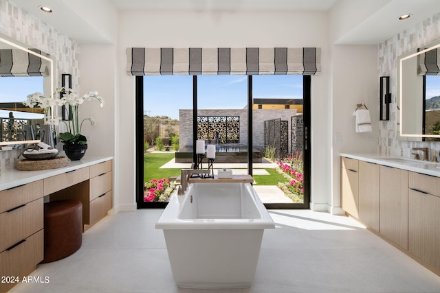 bathroom featuring a washtub, tasteful backsplash, vanity, and concrete floors