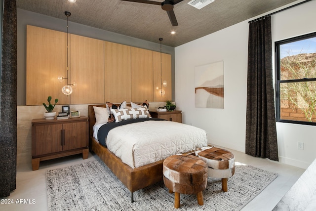 bedroom featuring ceiling fan and a textured ceiling