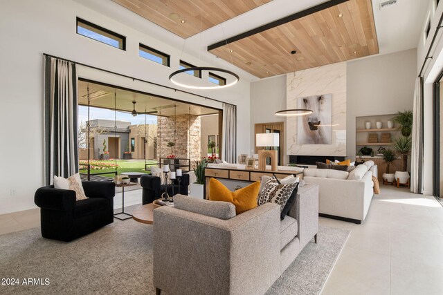 living room featuring a towering ceiling and wooden ceiling