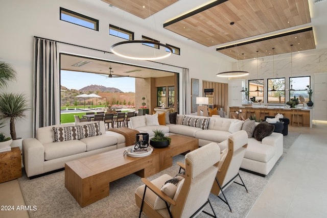 living room with a mountain view, wooden ceiling, and a high ceiling