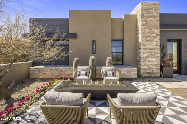 view of patio / terrace with an outdoor fire pit