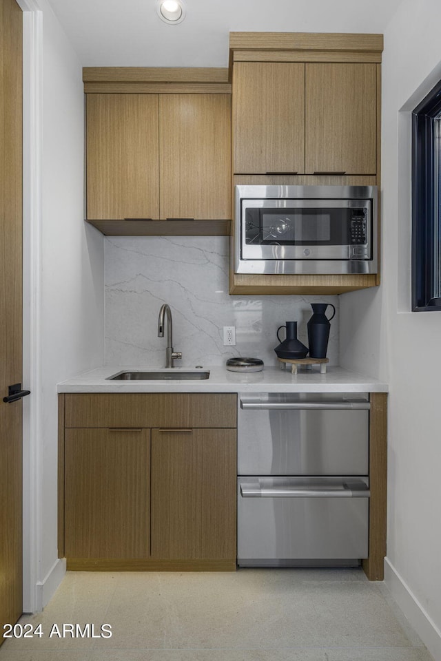 24046 N 126th Pl, Scottsdale, AZ 85255 - kitchen with stainless steel appliances, a sink, baseboards, tasteful backsplash, and light countertops