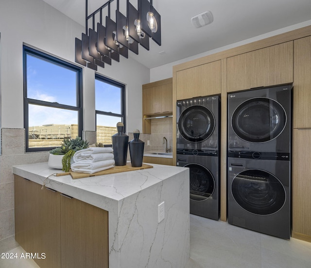 24046 N 126th Pl, Scottsdale, AZ 85255 - washroom with stacked washing machine and dryer and cabinet space