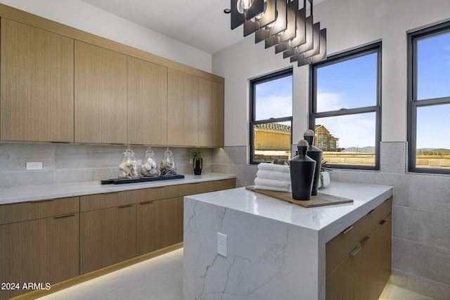 24046 N 126th Pl, Scottsdale, AZ 85255 - kitchen featuring modern cabinets, light stone counters, and decorative backsplash