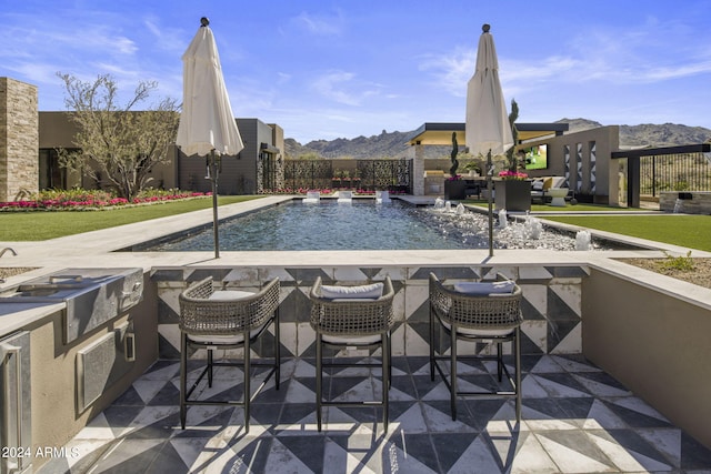 view of pool featuring a mountain view and pool water feature