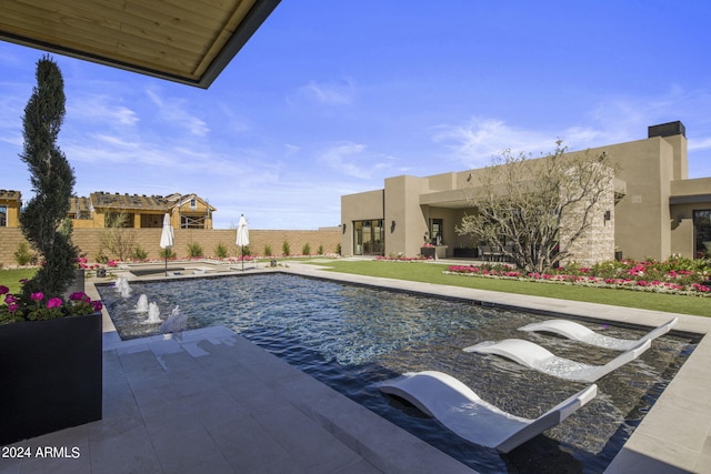 view of swimming pool with pool water feature and a patio