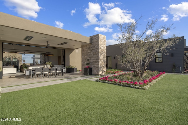 back of property featuring a yard and a patio area